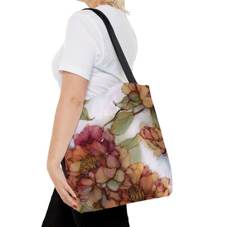 Vintage Peony Tote Bag with watercolor floral design and black handles worn by a woman in white shirt