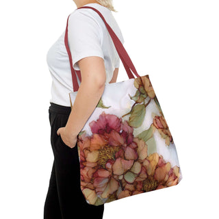 Woman carrying vintage peony tote bag with watercolor floral design and red handles