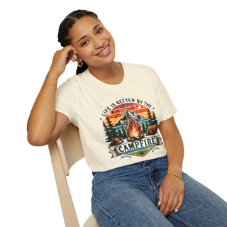 Woman wearing Camping Adventure Unisex T-Shirt with "Life is Better by the Campfire" design sitting on chair