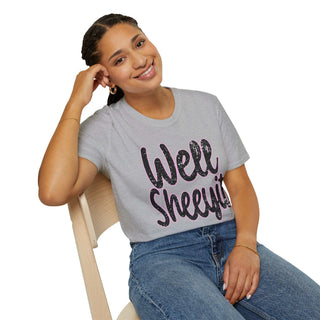 Woman wearing gray casual statement tee with "Well Sheeyit!" text sitting on chair