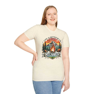 Unisex cream t-shirt with "Life is better by the campfire" graphic featuring a campfire and forest scene.