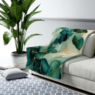 Emerald green leaf sherpa blanket with watercolor design and plush fleece backing