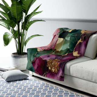 Luxurious green and plum sherpa blanket with jewel-toned floral print and plush fleece backing