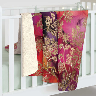Pink and gold velvet sherpa blanket with jewel-toned floral print and plush fleece backside
