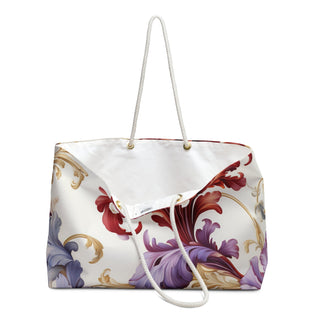 Elegant floral weekender bag with gold-accented cotton rope handles, spacious 24x13 inch size, and cream interior lining.