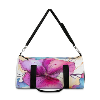 Small floral duffel bag with vibrant pink and purple flower design, black adjustable shoulder strap, and durable polyester Oxford canvas material.