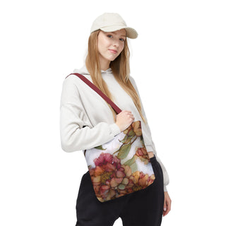 Woman wearing vintage peony tote bag with watercolor floral design and burgundy handles