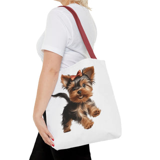 Yorkie puppy tote bag with hand-painted Yorkshire Terrier and red bow on white background, durable polyester with reinforced handles.