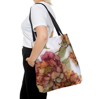 Vintage Peony Tote Bag with watercolor-style floral print and black handles worn by person in white t-shirt