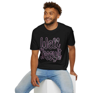 Man wearing black casual statement tee with "Well Sheeyit!" text design sitting on white block