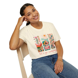 Woman wearing unisex softstyle t-shirt with colorful camping adventure design and "let's go camping" text sitting on chair