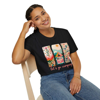 Woman wearing black Camping Adventure Unisex Softstyle T-Shirt with colorful camping design and "let's go camping" text, paired with blue jeans, smiling seated on wooden chair