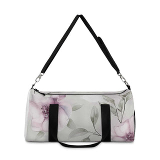 Small floral pattern duffel bag with black adjustable shoulder strap and double zipper closure