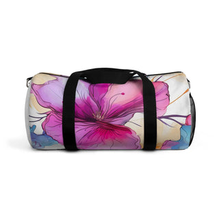Stylish floral duffel bag with vibrant pink and purple flower design, black straps, and spacious gym or travel use